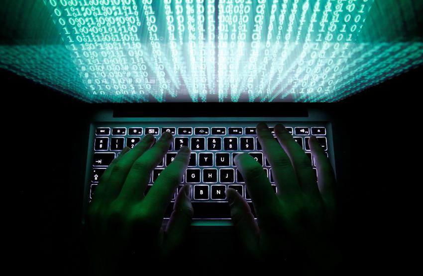 A man types on a computer keyboard in Warsaw in this February 28, 2013 illustration file picture. One of the largest ever cyber attacks is slowing global internet services after an organisation blocking "spam" content became a target, with some experts saying the disruption could get worse. To match INTERNET-ATTACK/ REUTERS/Kacper Pempel/Files (POLAND - Tags: BUSINESS SCIENCE TECHNOLOGY)